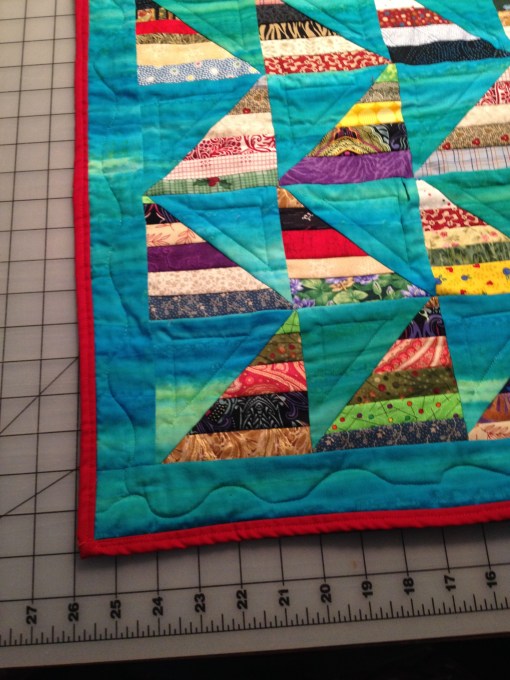 Binding the small quilt in red was a bright finishing touch