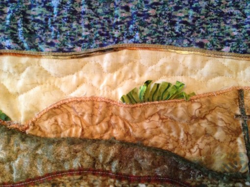 Textured quilting, and snipped greens for shrubs add dimension